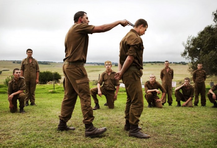 © Ilvy Njiokiktjien: World Press Photo: Afrikaner Blood              A sergeant shows boys at the Kommandokorps camp how to use a gun, South Africa.