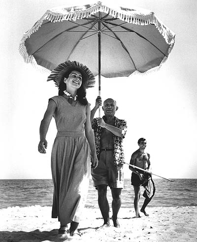 Pablo Picasso and Francoise Gilot (in the background is Picasso's Nephew Javier Vilaro), Golfe-Juan, France, 1948, Robert Capa Archive at the International Center of Photography, New York, Copyright 1996 Estate of Robert Capa