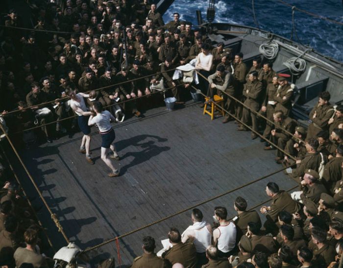 Robert Capa, [American and British soldiers watching a boxing match aboard boat from England to North Africa], June–July 1943. © International Center of Photography/Magnum Photos.